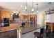 Spacious kitchen with granite counters, black appliances, breakfast bar and stylish pendant lighting at 8607 51St W Ave, Bradenton, FL 34210