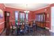 Formal dining room with dark wood furniture and red walls at 8607 51St W Ave, Bradenton, FL 34210