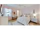 Bright bedroom with pink walls, white bed, and decor at 8980 Artisan Way, Sarasota, FL 34240