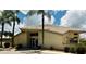 Exterior of a community building with a modern design and palm trees at 4419 Muirfield Dr, Bradenton, FL 34210