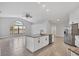 Modern kitchen with white cabinets, granite island, and stainless steel appliances at 4709 Foy Pl, Sarasota, FL 34243