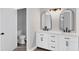 Elegant bathroom with double vanity, modern fixtures, and a separate toilet area at 4709 Foy Pl, Sarasota, FL 34243