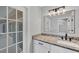 Charming bathroom with granite countertop, modern vanity, and access to patio at 4709 Foy Pl, Sarasota, FL 34243