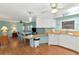 Bright and airy kitchen with light wood cabinets and laminate floors at 191 Palm Air Dr, Osprey, FL 34229
