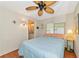 Cozy bedroom with ceiling fan, wood floors, and ensuite bathroom access at 191 Palm Air Dr, Osprey, FL 34229