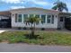 Bright and airy mobile home with a well-manicured lawn at 191 Palm Air Dr, Osprey, FL 34229