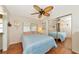 Bright bedroom with mirrored closet doors and ceiling fan at 191 Palm Air Dr, Osprey, FL 34229