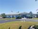 Community clubhouse with ample parking and welcoming entrance at 191 Palm Air Dr, Osprey, FL 34229