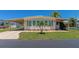 Inviting single-wide manufactured home with carport and landscaped lawn at 191 Palm Air Dr, Osprey, FL 34229