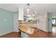 Charming kitchen with wood-look floors and an L-shaped breakfast bar at 191 Palm Air Dr, Osprey, FL 34229
