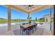 Covered patio with dining area and lake view at 8980 Artisan Way, Sarasota, FL 34240