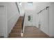 Bright entryway with light wood stairs and a modern barn door at 2420 Floyd St, Sarasota, FL 34239