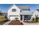 Two-story home with metal roof, shutters, and landscaped yard at 725 Anegada Ln, Sarasota, FL 34234