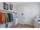Laundry room with sink, cabinetry, and hanging rod at 725 Anegada Ln, Sarasota, FL 34234