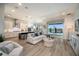 Open floor plan boasts a spacious kitchen with island and a light-filled living area at 725 Anegada Ln, Sarasota, FL 34234