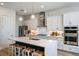 Modern kitchen with white cabinets, quartz counters, and stainless steel appliances at 725 Anegada Ln, Sarasota, FL 34234