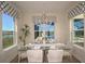 Elegant dining room with glass table and lake view at 725 Anegada Ln, Sarasota, FL 34234