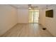 Spacious living area with wood-look floors and access to a patio at 6101 34Th W St # 1E, Bradenton, FL 34210