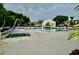 Community pool and spa with lounge chairs and patio tables at 6101 34Th W St # 1E, Bradenton, FL 34210