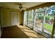 Bright screened porch with garden views and ceiling fan at 6101 34Th W St # 1E, Bradenton, FL 34210