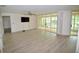 Spacious living room with wood-look floors and sliding doors to patio at 6101 34Th W St # 1E, Bradenton, FL 34210