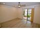 Bedroom with wood-look floors, sliding patio doors and ceiling fan at 6101 34Th W St # 1E, Bradenton, FL 34210