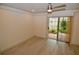 Bright bedroom with wood-look floors and sliding glass door to patio at 6101 34Th W St # 1E, Bradenton, FL 34210