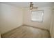 Bright bedroom with wood-look floors and window with blinds at 6101 34Th W St # 1E, Bradenton, FL 34210