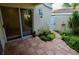 Private patio with terracotta tile flooring and lush landscaping at 6101 34Th W St # 1E, Bradenton, FL 34210
