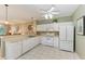 Bright kitchen with white appliances and view to living area at 2002 Bal Harbor Blvd # 1311, Punta Gorda, FL 33950