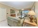 Living room boasts green sofa and access to patio at 2002 Bal Harbor Blvd # 1311, Punta Gorda, FL 33950