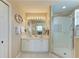 Bathroom with double vanity, large mirror, and shower stall at 2002 Bal Harbor Blvd # 1311, Punta Gorda, FL 33950