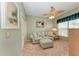 Sitting area with loveseat, ottoman, and ceiling fan at 2002 Bal Harbor Blvd # 1311, Punta Gorda, FL 33950