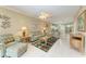 Spacious living room with green sofas and access to patio at 2002 Bal Harbor Blvd # 1311, Punta Gorda, FL 33950