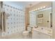 Bathroom with shower/tub combo, vanity, and palm tree decor at 2002 Bal Harbor Blvd # 1311, Punta Gorda, FL 33950