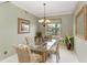 Dining room with glass table, palm-print chairs, and water view at 2002 Bal Harbor Blvd # 1311, Punta Gorda, FL 33950