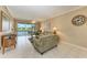 Living room with green sofa, water view, and ceiling fan at 2002 Bal Harbor Blvd # 1311, Punta Gorda, FL 33950