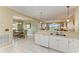 Kitchen features white cabinetry, tile floors, and breakfast bar at 2002 Bal Harbor Blvd # 1311, Punta Gorda, FL 33950