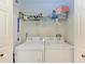 Bright laundry room with washer, dryer, and shelving at 2002 Bal Harbor Blvd # 1311, Punta Gorda, FL 33950