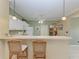 View of kitchen with breakfast bar and wicker stools at 2002 Bal Harbor Blvd # 1311, Punta Gorda, FL 33950