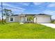New single story home with attached garage and landscaped lawn at 12154 Van Loon Ave, Port Charlotte, FL 33981
