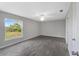 Spacious bedroom with large window and gray tile floor at 12154 Van Loon Ave, Port Charlotte, FL 33981
