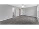 Large bedroom with ceiling fan, gray tile floor, and access to bathroom at 12154 Van Loon Ave, Port Charlotte, FL 33981