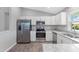 Modern kitchen with stainless steel appliances and granite countertops at 12154 Van Loon Ave, Port Charlotte, FL 33981