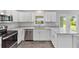 L-shaped kitchen with granite countertops and stainless steel appliances at 12154 Van Loon Ave, Port Charlotte, FL 33981