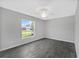 Bright bedroom featuring a large window and gray tile flooring at 12154 Van Loon Ave, Port Charlotte, FL 33981