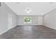 Bright living area with neutral walls, wood-look floors, and high ceilings at 12154 Van Loon Ave, Port Charlotte, FL 33981
