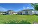 Expansive backyard with green grass, view of a neighboring home, and blue skies at 429 Alberata Way, Nokomis, FL 34275