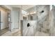 Bathroom features a glass shower with gray marble-look tiles, and modern fixtures at 429 Alberata Way, Nokomis, FL 34275