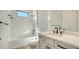 Bathroom featuring a shower over the tub with white tiling and dark fixtures at 429 Alberata Way, Nokomis, FL 34275